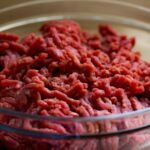 High-quality image of fresh ground beef in a glass bowl, ideal for culinary and food-related themes.